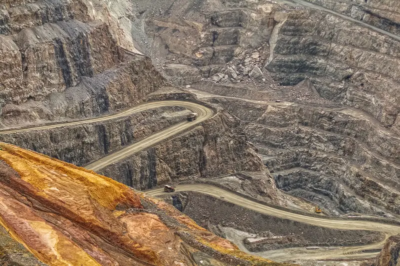 Haul roads winding down the terraces of an open-pit mine